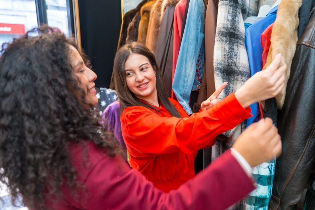 Friends choosing clothes in a second hand store